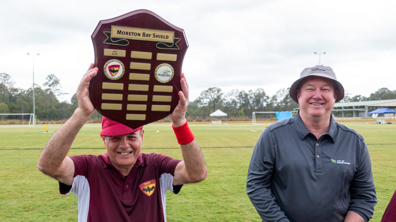 BATS Captain Paul Szep holds up the Moreton Bay Shield after the end of a very close Beep Cricket match between the BATS and the Moreton Bay City Mayor's XI.